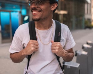 man in white crew neck t-shirt wearing blue cap and black sunglasses