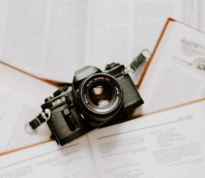 black nikon dslr camera on white printer paper