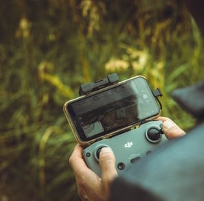 person holding black and gray digital camera