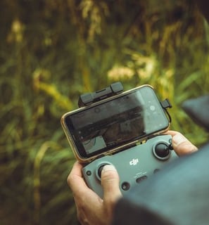 person holding black and gray digital camera