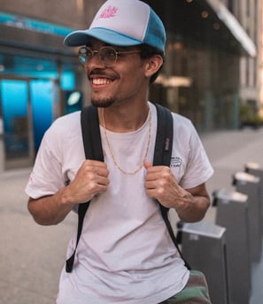 man in white crew neck t-shirt wearing blue cap and black sunglasses