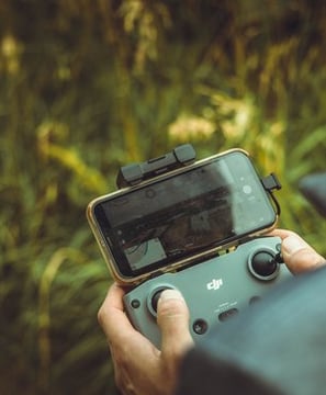 person holding black and gray digital camera