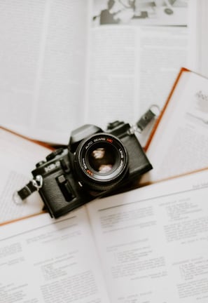 black nikon dslr camera on white printer paper