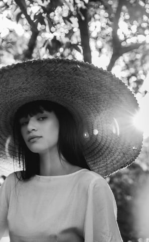 woman in white crew neck shirt wearing brown sun hat