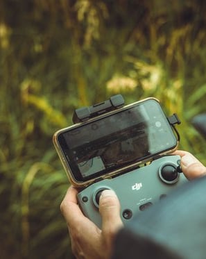 person holding black and gray digital camera