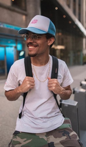man in white crew neck t-shirt wearing blue cap and black sunglasses
