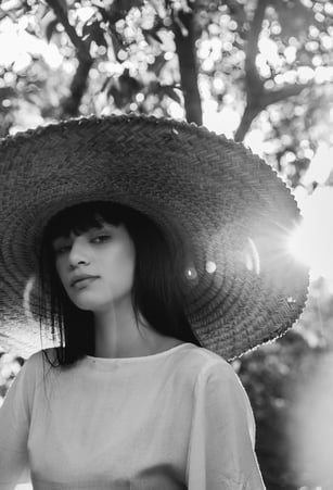 woman in white crew neck shirt wearing brown sun hat