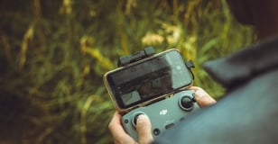 person holding black and gray digital camera