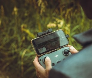 person holding black and gray digital camera