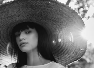 woman in white crew neck shirt wearing brown sun hat