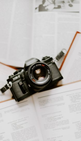 black nikon dslr camera on white printer paper