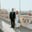 man in black suit standing beside woman in white wedding dress