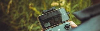person holding black and gray digital camera