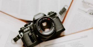 black nikon dslr camera on white printer paper
