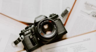 black nikon dslr camera on white printer paper