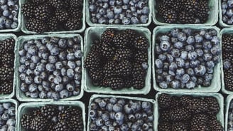 black berries on black surface