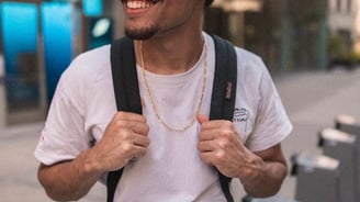 man in white crew neck t-shirt wearing blue cap and black sunglasses