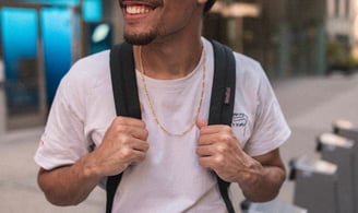 man in white crew neck t-shirt wearing blue cap and black sunglasses