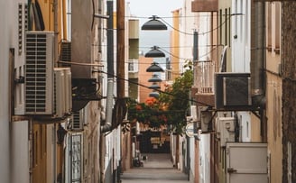 empty hallway between concrete buildings during daytime