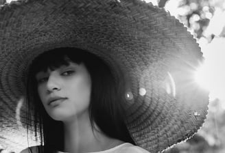 woman in white crew neck shirt wearing brown sun hat