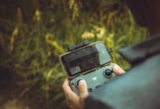 person holding black and gray digital camera