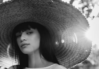 woman in white crew neck shirt wearing brown sun hat