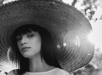 woman in white crew neck shirt wearing brown sun hat