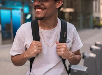 man in white crew neck t-shirt wearing blue cap and black sunglasses