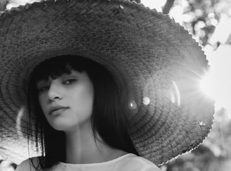 woman in white crew neck shirt wearing brown sun hat
