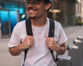 man in white crew neck t-shirt wearing blue cap and black sunglasses