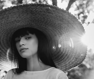 woman in white crew neck shirt wearing brown sun hat