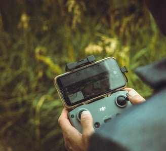 person holding black and gray digital camera