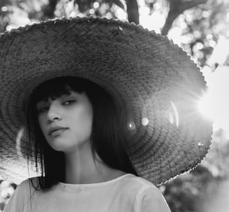 woman in white crew neck shirt wearing brown sun hat