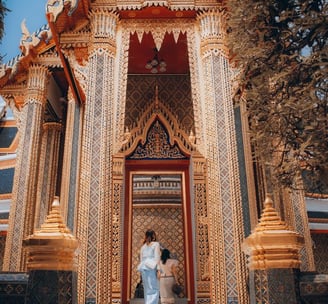 man and woman standing in front of brown concrete building during daytime