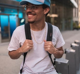 man in white crew neck t-shirt wearing blue cap and black sunglasses