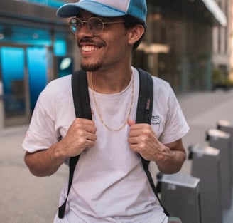 man in white crew neck t-shirt wearing blue cap and black sunglasses
