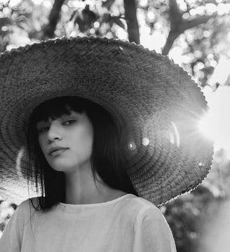 woman in white crew neck shirt wearing brown sun hat