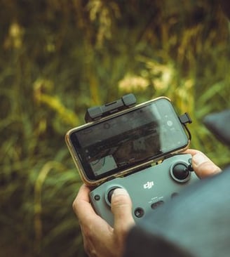 person holding black and gray digital camera