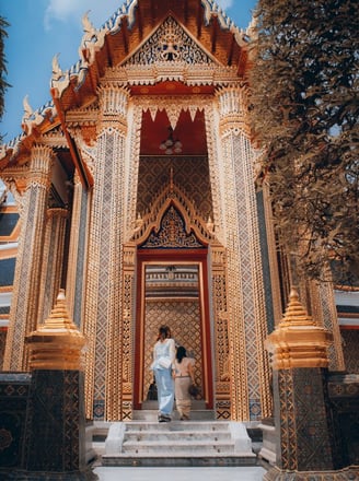 man and woman standing in front of brown concrete building during daytime