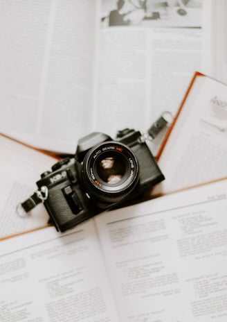 black nikon dslr camera on white printer paper