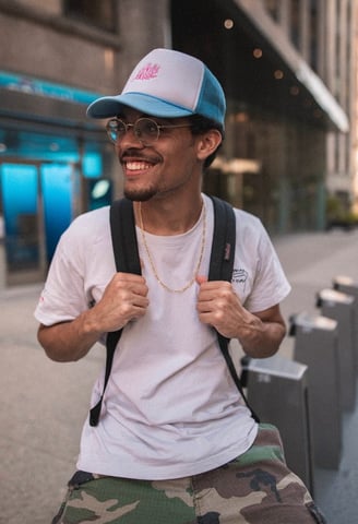 man in white crew neck t-shirt wearing blue cap and black sunglasses