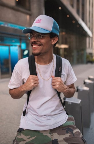 man in white crew neck t-shirt wearing blue cap and black sunglasses