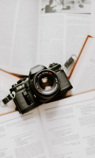 black nikon dslr camera on white printer paper