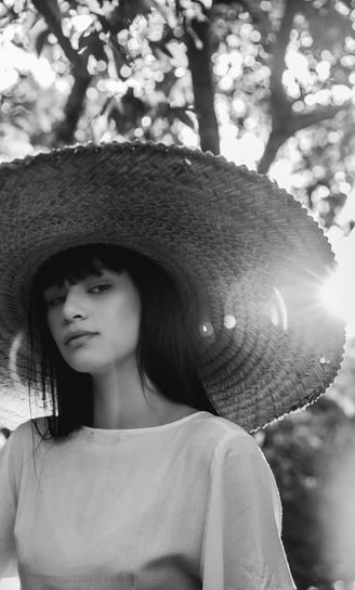 woman in white crew neck shirt wearing brown sun hat