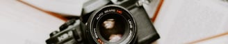 black nikon dslr camera on white printer paper