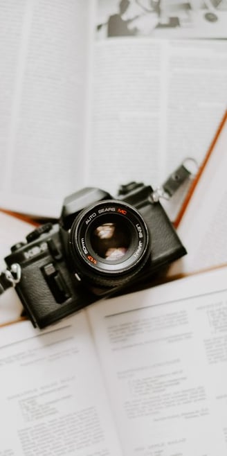 black nikon dslr camera on white printer paper
