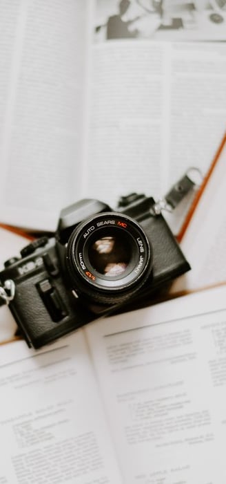 black nikon dslr camera on white printer paper