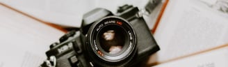 black nikon dslr camera on white printer paper