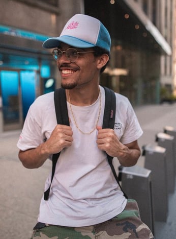 man in white crew neck t-shirt wearing blue cap and black sunglasses