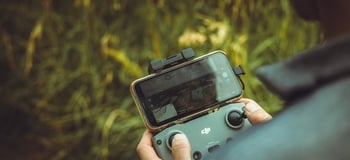 person holding black and gray digital camera